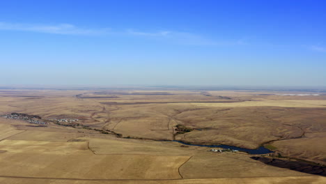 aerial view of rural landscape with hills, fields, and a lake