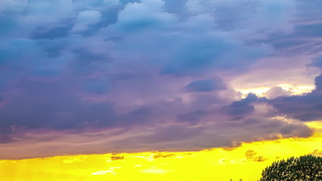 a reveal shot of a colourful wind shear and dramatic sky with clouds moving horizontally