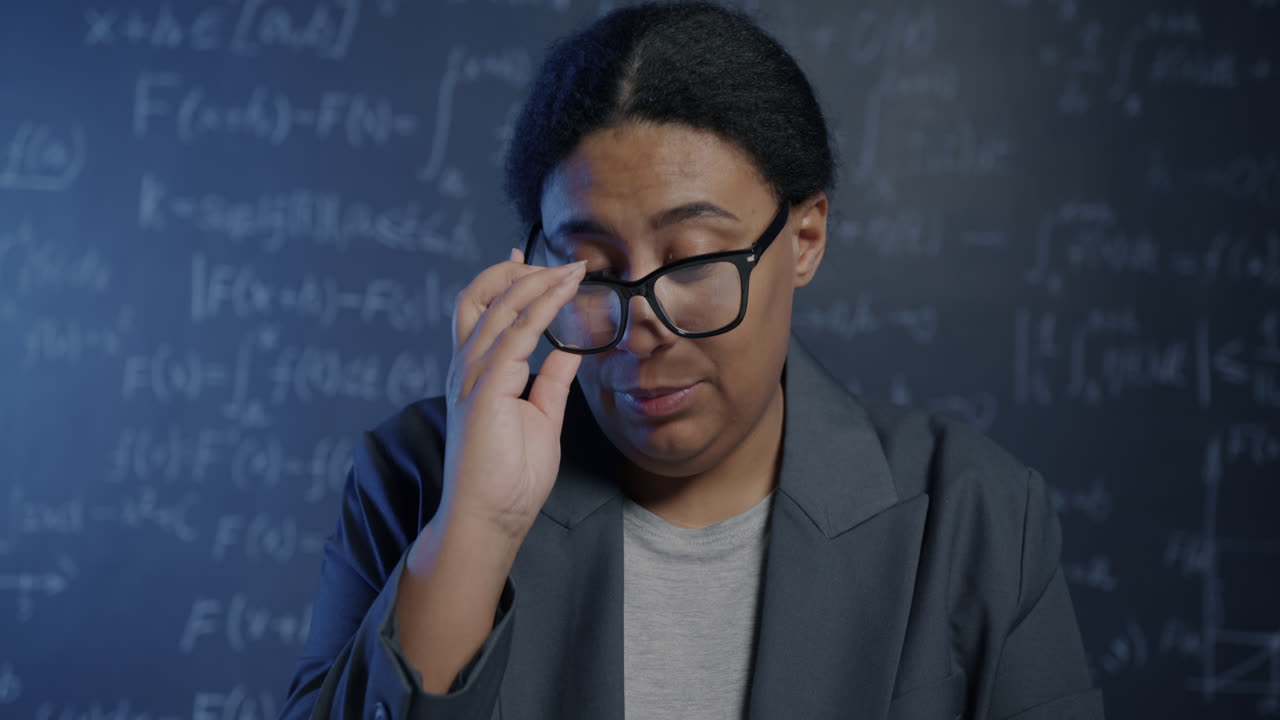 Woman Professor Explaining Mathematics on Chalkboard