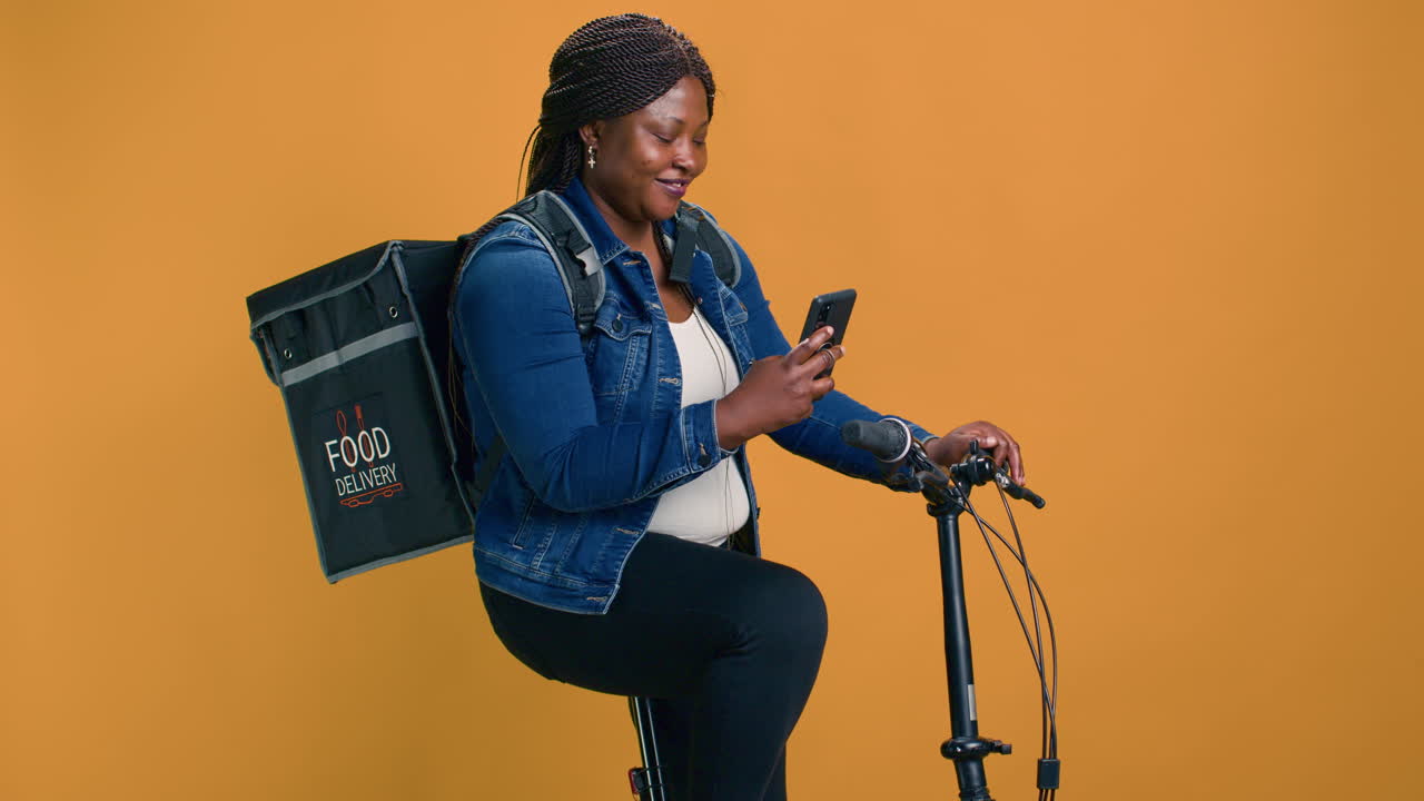 Woman On Bike While Holding A Cellphone
