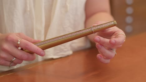 golden-diamond-ring-getting-measured-by-female-hands