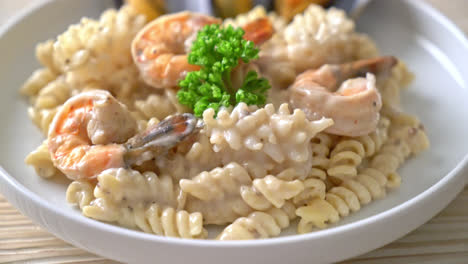 spiral pasta mushroom cream sauce with seafood - italian food style