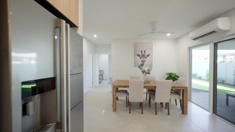 modern interior view of a display home kitchen leading to a laundry area, featuring sleek cabinetry, countertops, and contemporary design elements