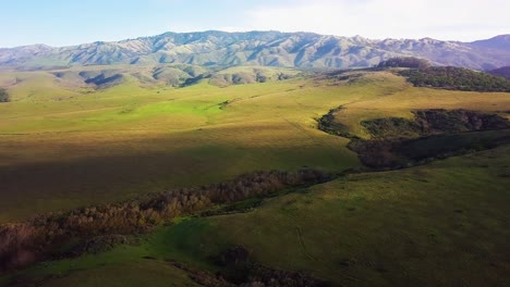 flying over rolling california hills at sunrise