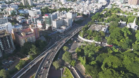 an aerial video of chennai city centre in the morning would offer a breathtaking view of the city awakening. the sun would cast a golden glow over the city. clouds and buildings blue sky gemini bridge