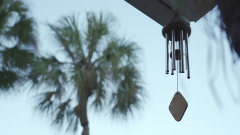 calming and relaxing view of a wind chime blowing in a tropical garden