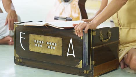 hands playing the harmonium at spiritual yoga mantra retreat concert