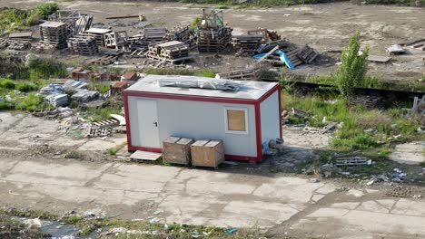 temporary construction site office amidst disorganized materials