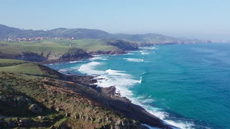 Panoramic-Aerial-Shot-Of-Green-Coastal-Landscape-In-Spain,-Playa-de-Tagle