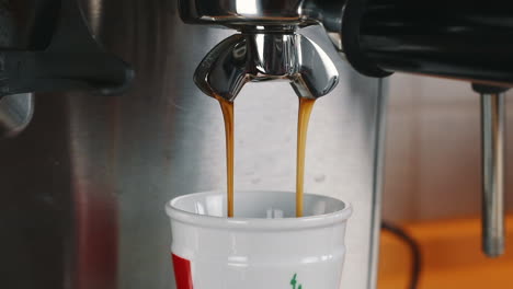 coffee gently flowing into espresso cup