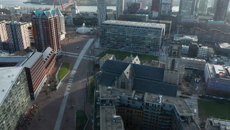 cityscape with markthal building and laurenskerk church in rotterdam, netherlands - aerial drone shot