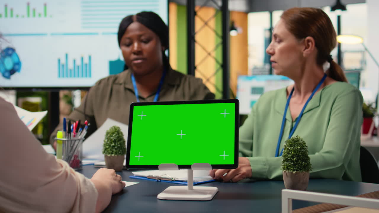 Vertical Video Corporate women gather with a chroma key display in modern work environment