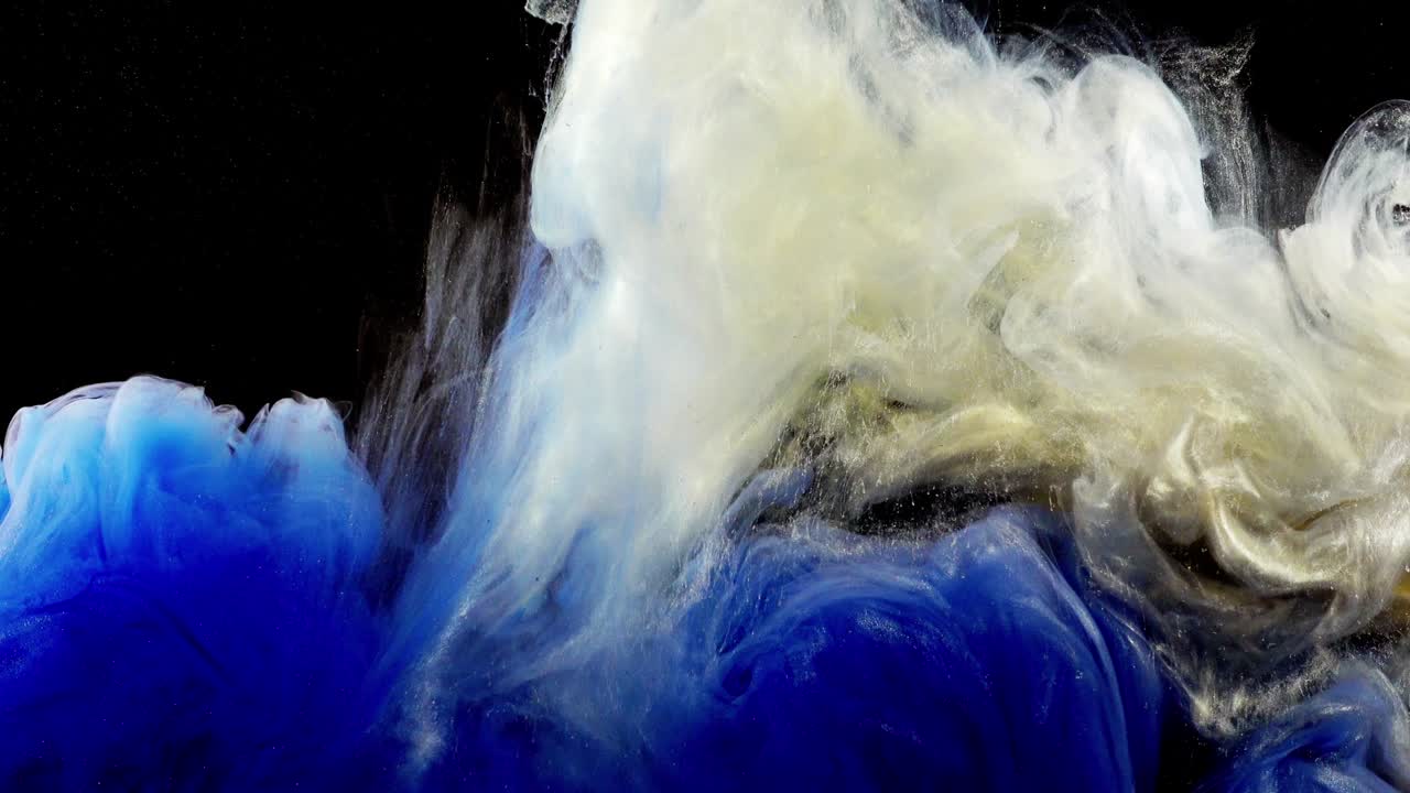 Abstract forms. Shooting on a black background. Mixing of paints