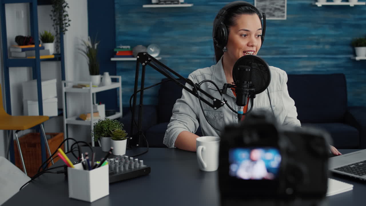 Attractive social media influencer speaking to audience at microphone