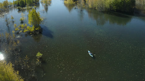 Aerial-View-Of-A-Kayak-Paddling-On-Abraham-Lake-During-Autumn-In-Alberta-Canada