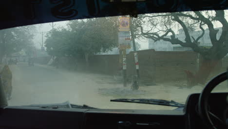 a vehicle drives past a rickshaw driver onto a street