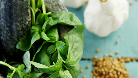 Mortar-and-pestle-with-herbs-and-spices-on-wooden-table-4k