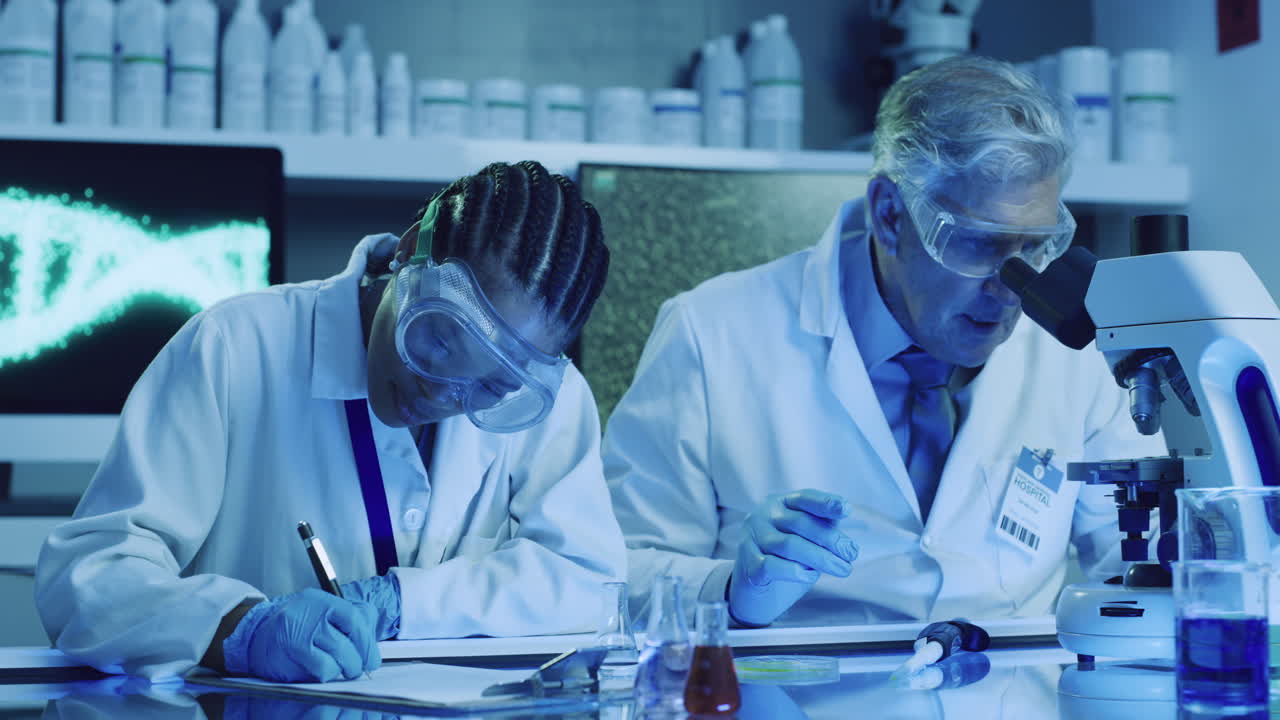 Two scientists research a virus in a laboratory