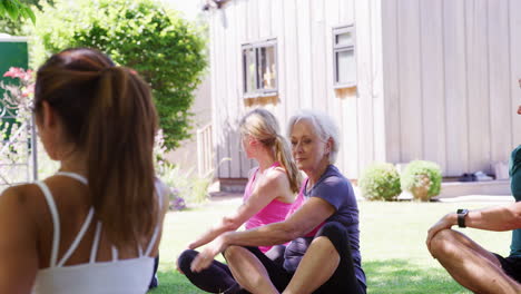 female instructor leading outdoor yoga class