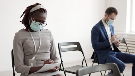 african businesswoman in medical mask writing