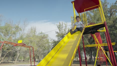 a little boy sliding down a slide