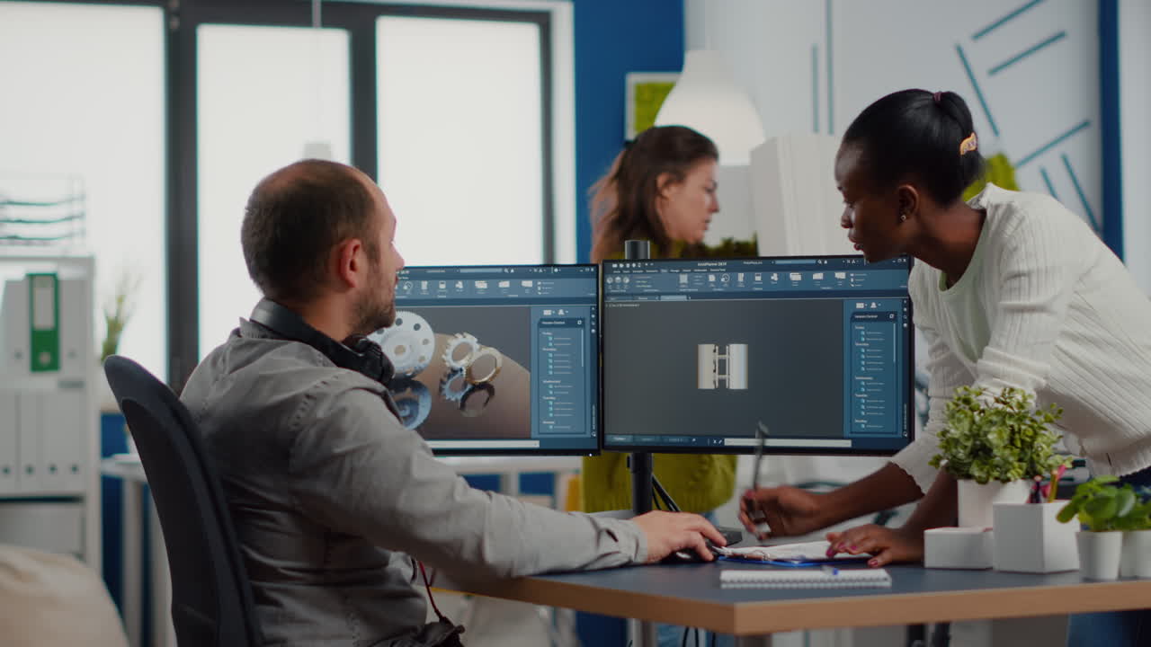 Black employee and project manager analysing mechanical metalic parts