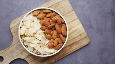 Top-view-of-almond-nut-and-slice-in-a-bowl-on-table