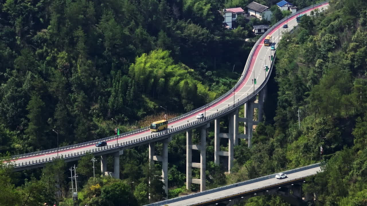 Telephoto drone shot of traffic on a highway bridge, in sunny Zhangjiajie, China