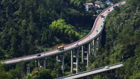 telephoto drone shot of traffic on a highway bridge, in sunny zhangjiajie, china