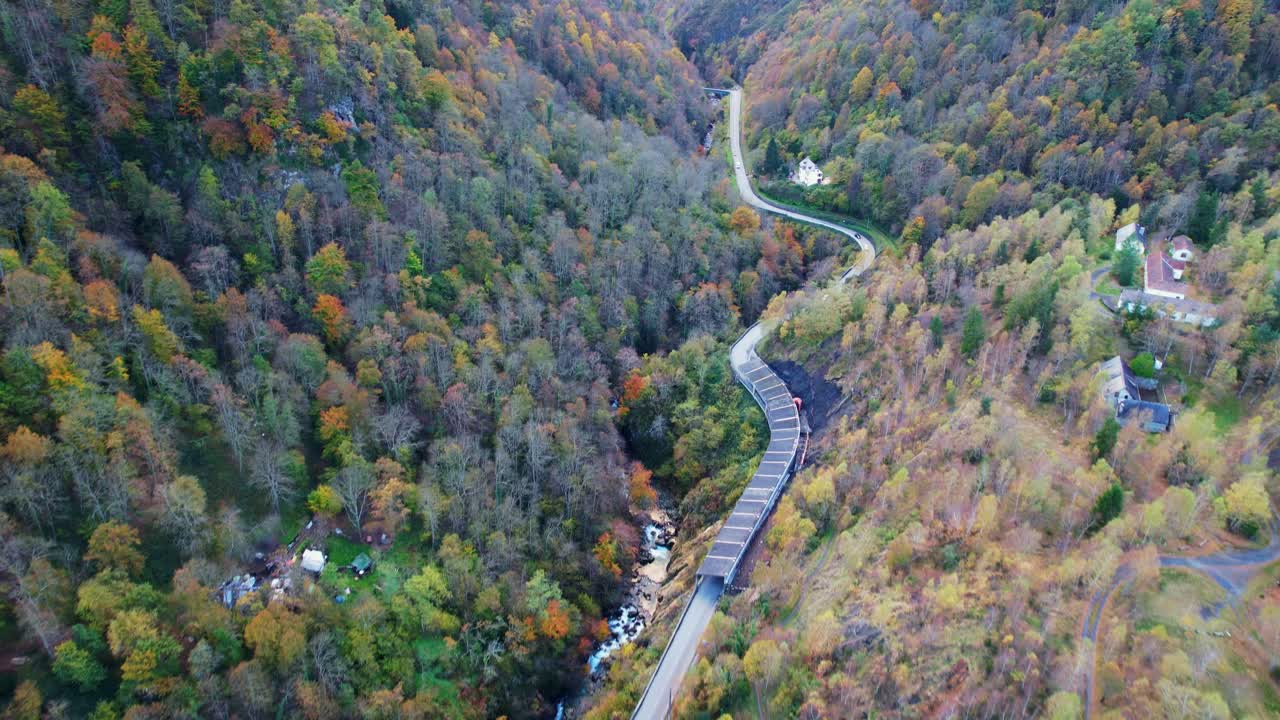 Scenic road through French Pyrenees forest in autumn towards Cauterets