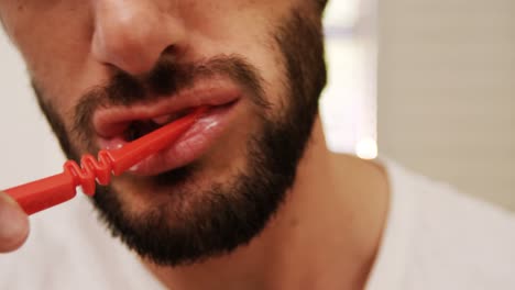 man brushing his teeth in bathroom