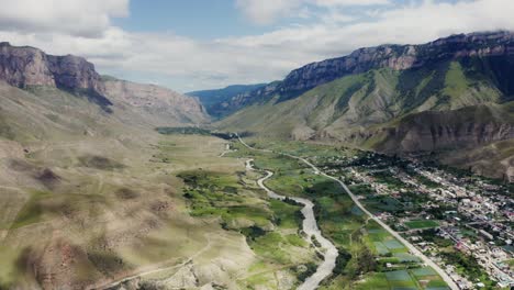 aerial view of mountain valley with river and town