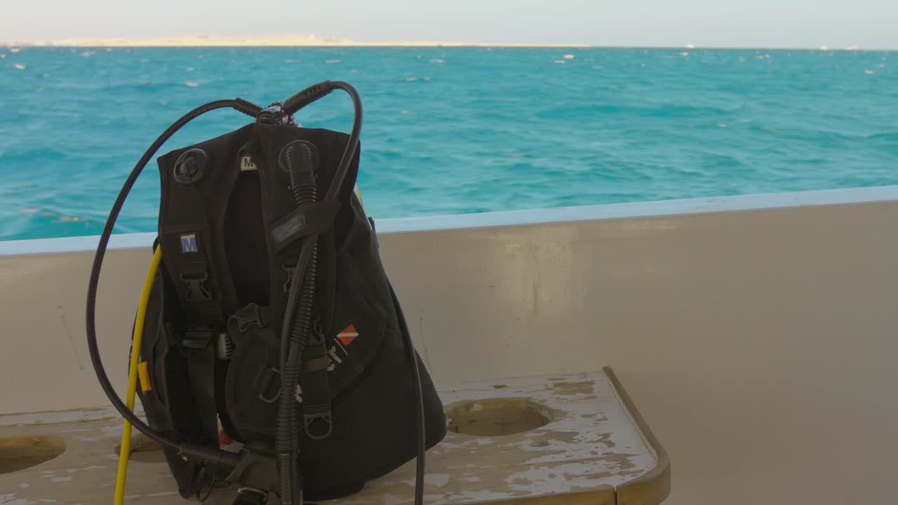 Closeup view of diving backpack with blue sea at background in Hurghada, Egypt.
