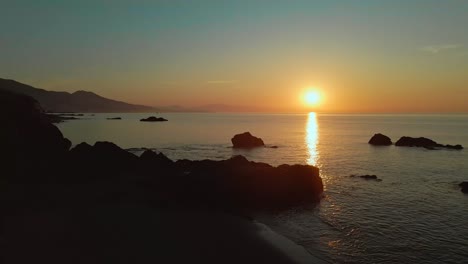 aerial reveal of fire sunset at fuengirola beach sea, sun coast, málaga spain