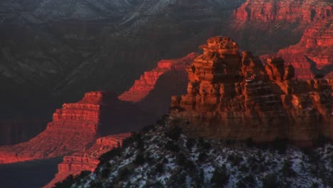 Medium-Shot-Looking-Down-On-Interior-Of-Grand-Canyon-National-Park-In-Winter-With-Sandstone-Pillars-Canyon-Walls-And-Snow