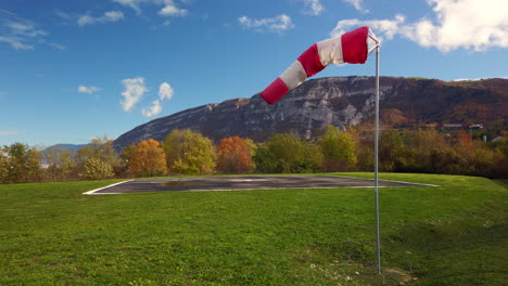 Windsock-moving-in-the-wind-next-to-an-helipad-in-4k