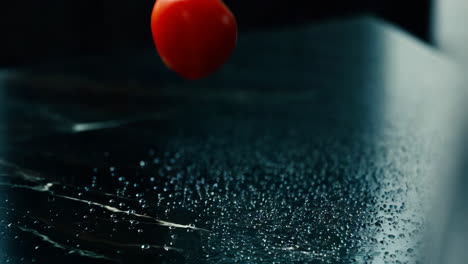 red tomato on a wet marble table