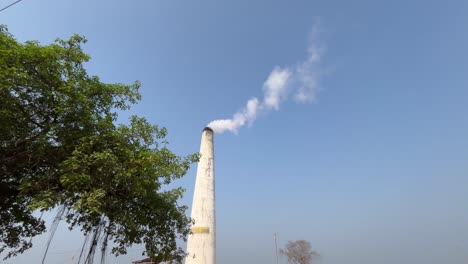 black smoke billowing from the funnel is mixing with the sky.