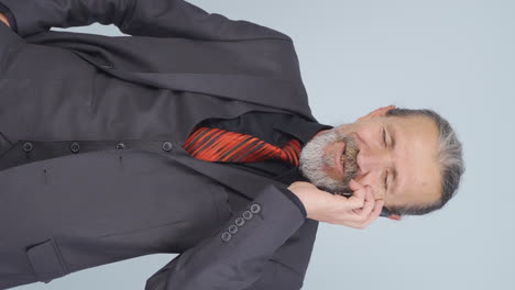 Vertical-video-of-Old-businessman-happily-speaking-to-camera.