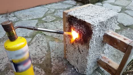 Close-up-of-a-hempcrete-block-being-flamed-by-a-gas-burner