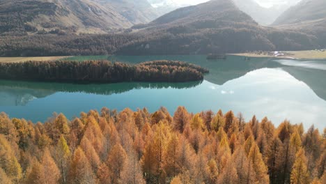 Magical-other-worldly-view-of-Klontalersee-lake-with-orange-Alpine-trees