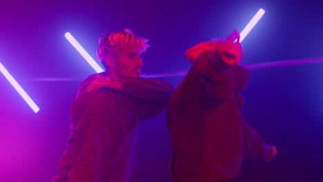 Trendy-couple-performing-dance-in-nightclub-closeup.-Girl-dancing-with-cool-guy.