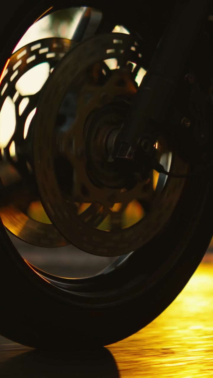 Close-up of a Motorcycle Front Wheel Spinning on the Road