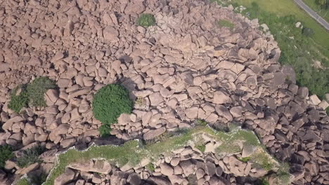 Aerial:-Granite-boulders-create-natural-fortifications-at-Hampi,-India