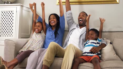 family watching television in living room 4k