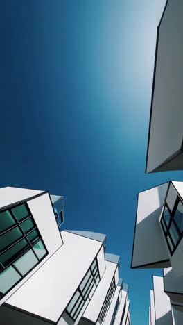 modern geometric buildings against clear blue sky