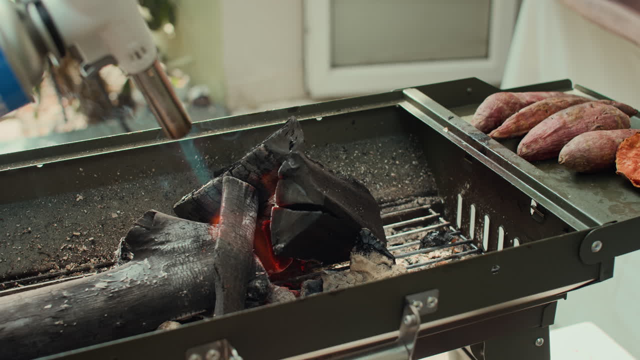 Hands of Man Using Gas-lighter when Preparing Barbecue for Party