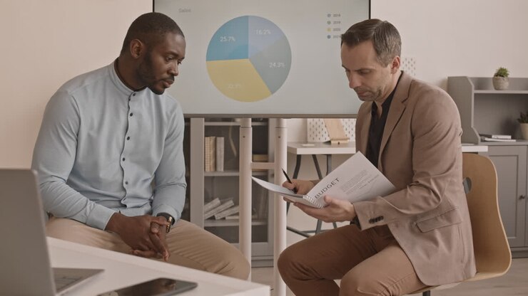 Diverse Colleagues Discussing Company Performance