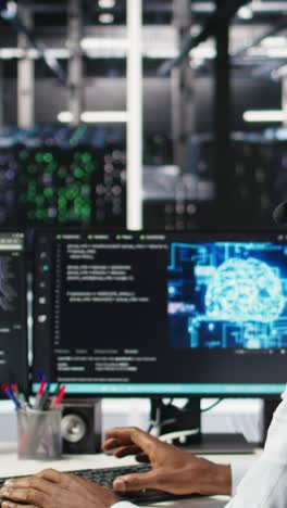 vertical video data center employee talking in headset mic, coordinating technicians