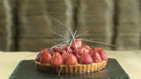 strawberry cake topped with powdered sugar and nuts